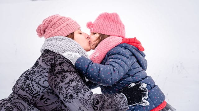 snow, mother daughter, child, pink hat, kiss, hug