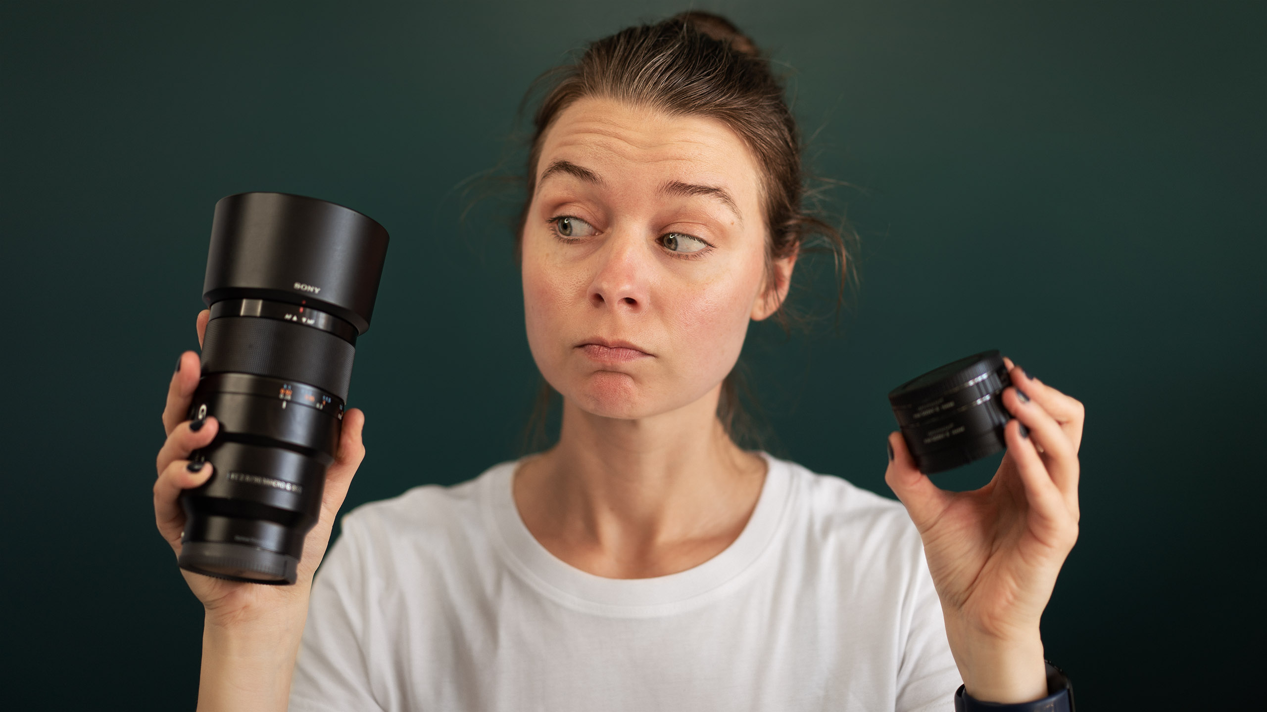 Female photographer holding macro lens extension tubes